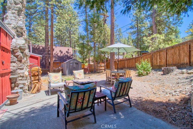 1815 Thrush Rd, Wrightwood, CA 92397 - fenced backyard with a storage shed, a fire pit, and a patio area