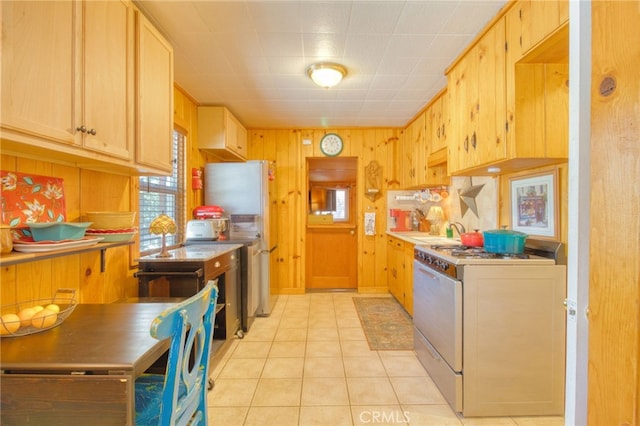 1815 Thrush Rd, Wrightwood, CA 92397 - kitchen featuring wooden walls, light countertops, freestanding refrigerator, white range with gas cooktop, and light tile patterned floors