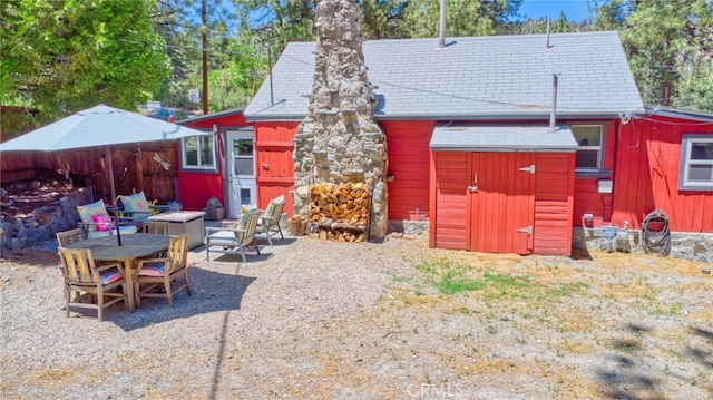 1815 Thrush Rd, Wrightwood, CA 92397 - rear view of house with a patio area, an outdoor fire pit, and a chimney