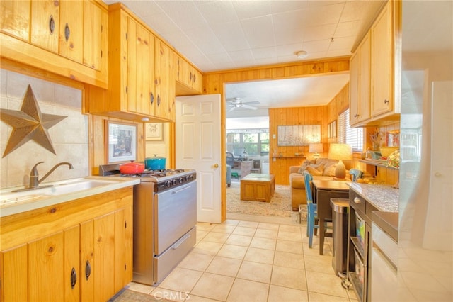 1815 Thrush Rd, Wrightwood, CA 92397 - kitchen with white gas stove, wood walls, light countertops, light tile patterned floors, and a ceiling fan