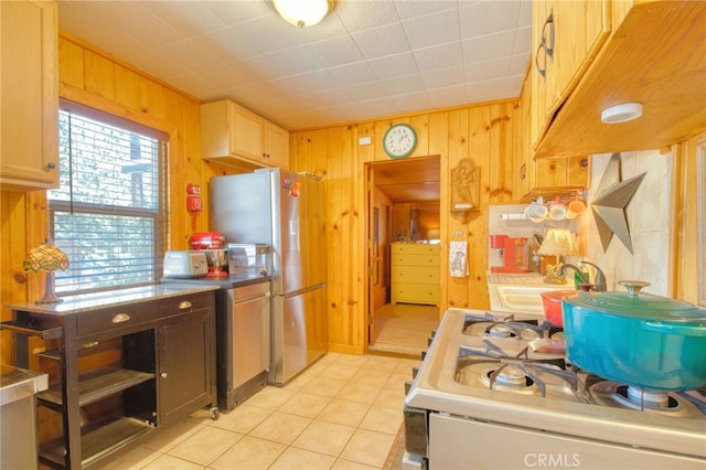 1815 Thrush Rd, Wrightwood, CA 92397 - kitchen with wood walls, white gas stove, light tile patterned floors, and stainless steel fridge with ice dispenser