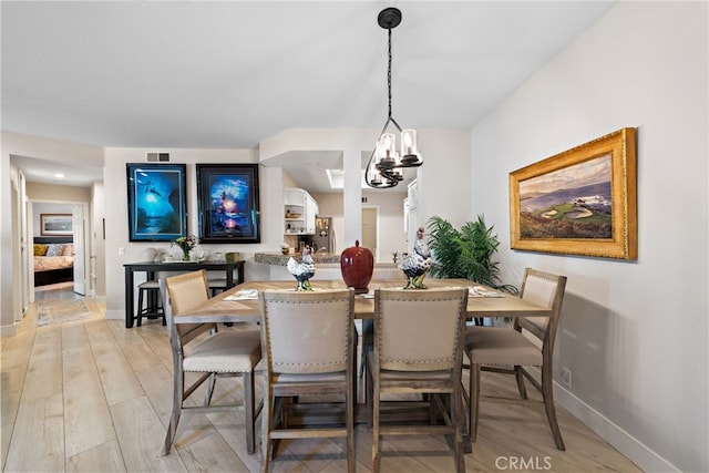 29 Baycrest Ct Unit 16, Newport Beach, CA 92660 - dining space featuring light wood finished floors and a chandelier