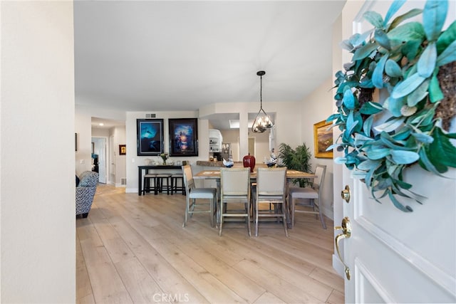 29 Baycrest Ct Unit 16, Newport Beach, CA 92660 - dining space with light wood-style flooring and a chandelier