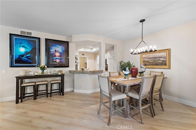 29 Baycrest Ct Unit 16, Newport Beach, CA 92660 - dining area with light wood-type flooring and a chandelier