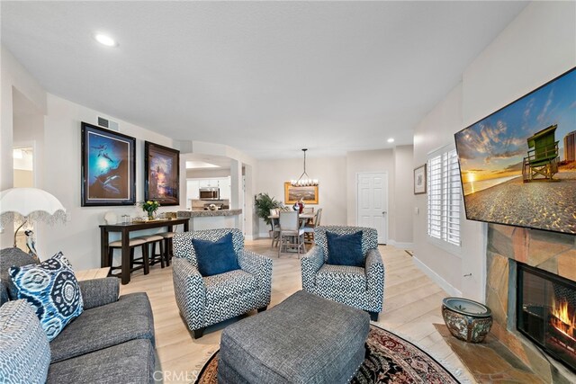 29 Baycrest Ct Unit 16, Newport Beach, CA 92660 - living room with a fireplace, a chandelier, light wood-style flooring, and recessed lighting