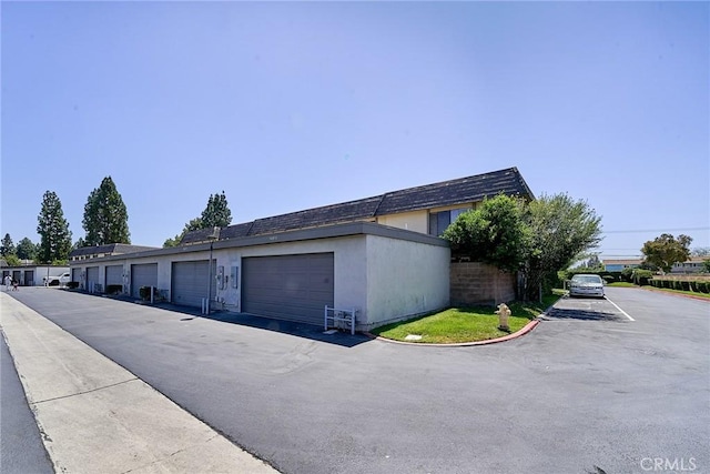 16011 Sugarpine Ln, Cerritos, CA 90703 - view of property exterior featuring community garages and stucco siding