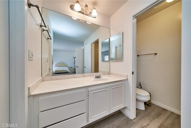 16011 Sugarpine Ln, Cerritos, CA 90703 - ensuite bathroom featuring vanity and wood finished floors
