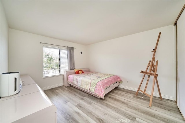 16011 Sugarpine Ln, Cerritos, CA 90703 - bedroom with light wood-style flooring and baseboards