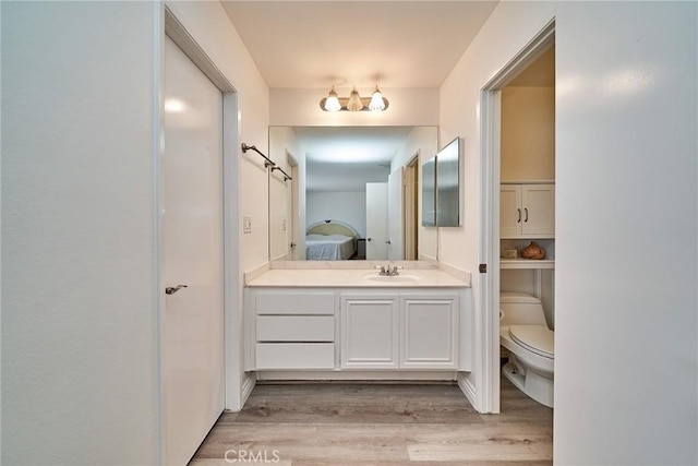 16011 Sugarpine Ln, Cerritos, CA 90703 - bathroom featuring vanity, wood finished floors, and ensuite bath