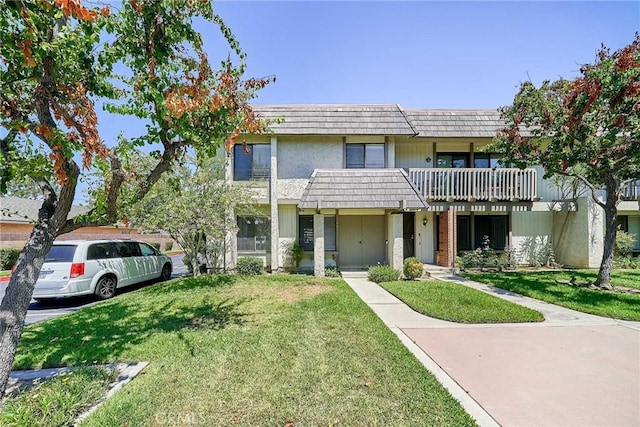 16011 Sugarpine Ln, Cerritos, CA 90703 - townhome / multi-family property with mansard roof, a front lawn, and a balcony