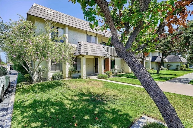 16011 Sugarpine Ln, Cerritos, CA 90703 - view of front of property with mansard roof, stucco siding, and a front yard