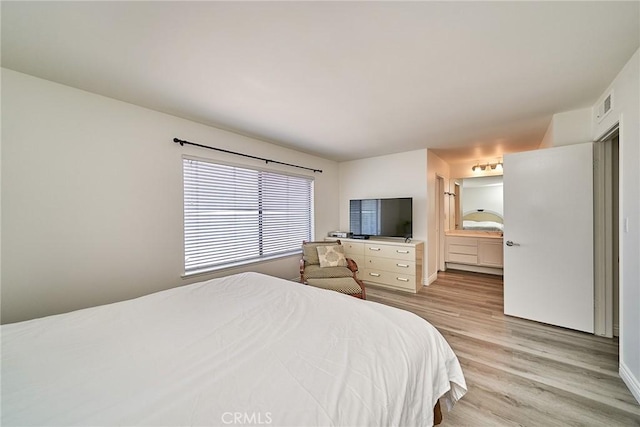 16011 Sugarpine Ln, Cerritos, CA 90703 - bedroom with light wood-style floors and connected bathroom