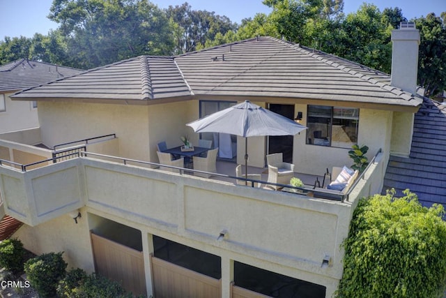 644 Orwell Ln, Ventura, CA 93003 - rear view of house with stucco siding, a chimney, and a tile roof