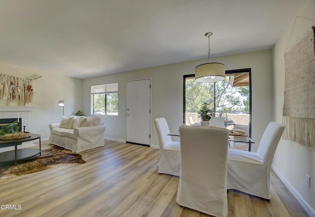 644 Orwell Ln, Ventura, CA 93003 - dining space featuring light wood finished floors and a tile fireplace