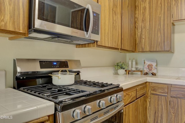 644 Orwell Ln, Ventura, CA 93003 - kitchen featuring stainless steel appliances, tile countertops, and backsplash