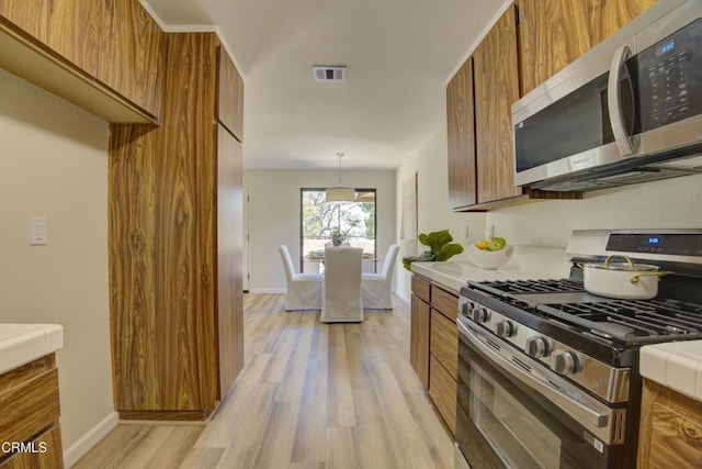 644 Orwell Ln, Ventura, CA 93003 - kitchen with appliances with stainless steel finishes and brown cabinets