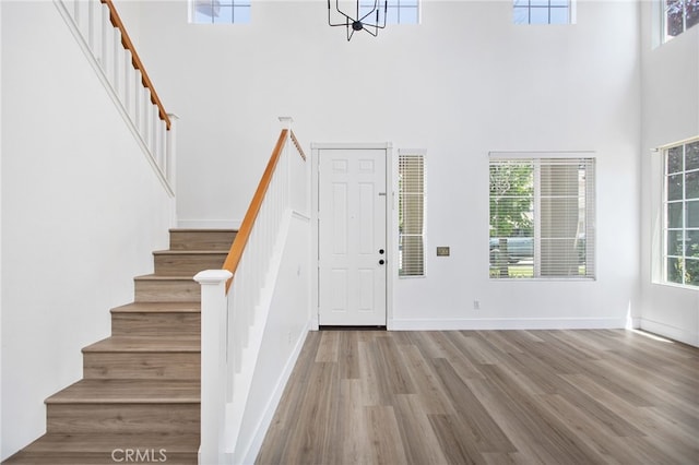 31257 Casera Ct, Menifee, CA 92584 - foyer with a towering ceiling, stairs, and wood finished floors