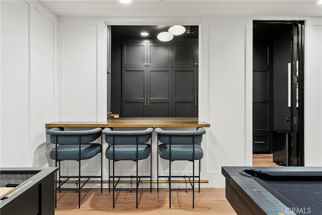 4 Thomas Rd, Ladera Ranch, CA 92694 - bar area featuring light wood-type flooring, a decorative wall, and billiards