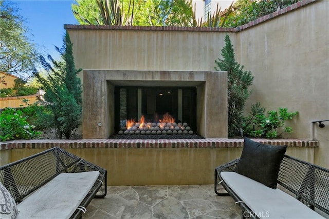 4 Thomas Rd, Ladera Ranch, CA 92694 - view of patio featuring a lit fireplace