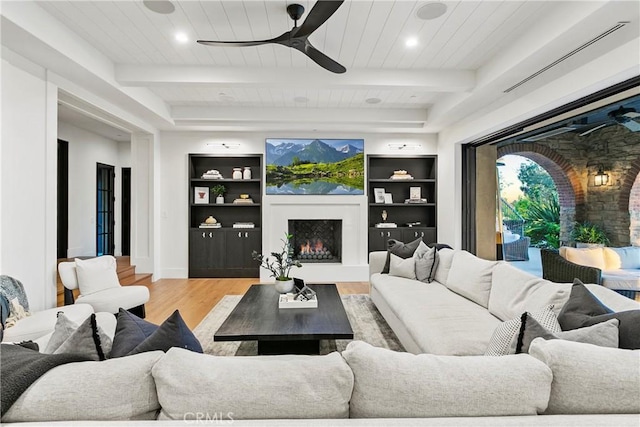 4 Thomas Rd, Ladera Ranch, CA 92694 - living area with a warm lit fireplace, a ceiling fan, light wood-type flooring, a wood ceiling with exposed beams, and recessed lighting