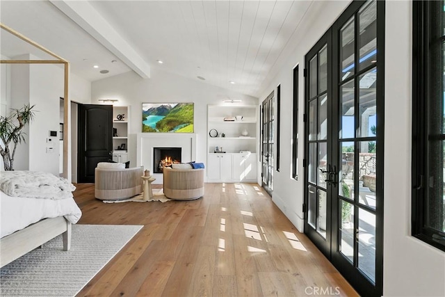 4 Thomas Rd, Ladera Ranch, CA 92694 - bedroom featuring french doors, light wood-style flooring, and a lit fireplace