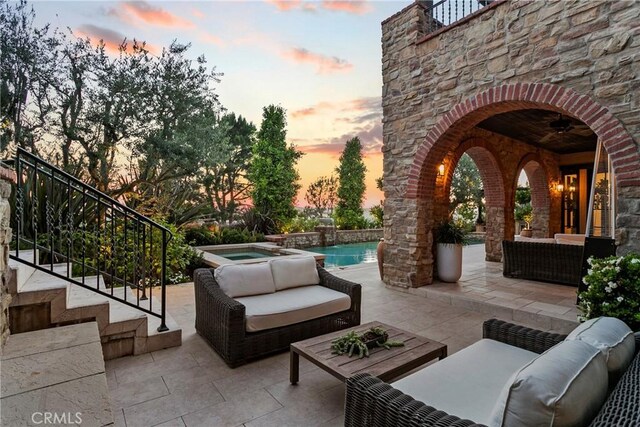 4 Thomas Rd, Ladera Ranch, CA 92694 - patio terrace at dusk with an outdoor living space, an in-ground hot tub, a patio area, and stairway