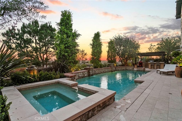 4 Thomas Rd, Ladera Ranch, CA 92694 - pool at dusk with an in-ground hot tub, an outdoor pool, an outdoor kitchen, and a patio