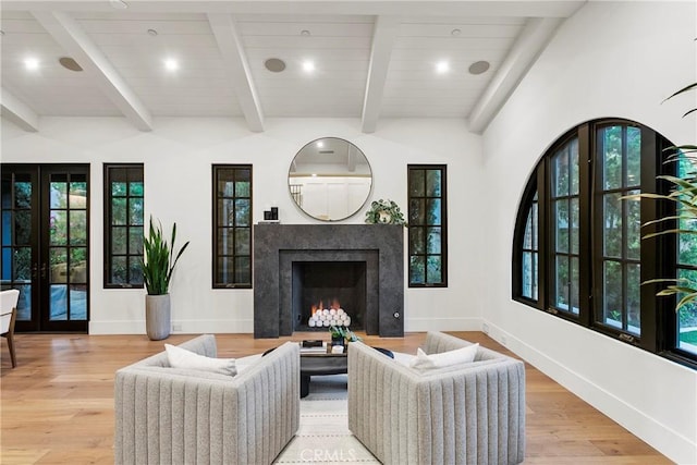 4 Thomas Rd, Ladera Ranch, CA 92694 - living area featuring french doors, light wood-style flooring, a high end fireplace, beam ceiling, and recessed lighting