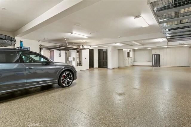 4 Thomas Rd, Ladera Ranch, CA 92694 - garage featuring freestanding refrigerator and a garage door opener