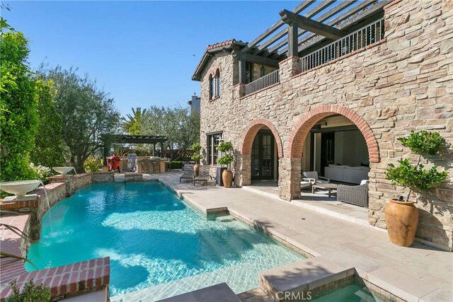 4 Thomas Rd, Ladera Ranch, CA 92694 - swimming pool with a patio, a pergola, an outdoor kitchen, and an outdoor living space