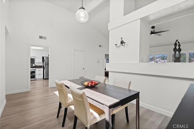 29 Morena Unit 35, Irvine, CA 92612 - dining area with high vaulted ceiling, light wood-style floors, and a ceiling fan