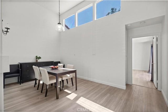 29 Morena Unit 35, Irvine, CA 92612 - dining space featuring light wood-style floors and a towering ceiling