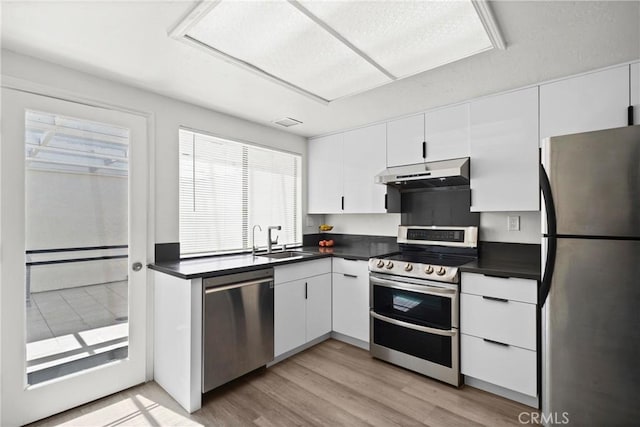 29 Morena Unit 35, Irvine, CA 92612 - kitchen featuring stainless steel appliances, under cabinet range hood, and dark countertops