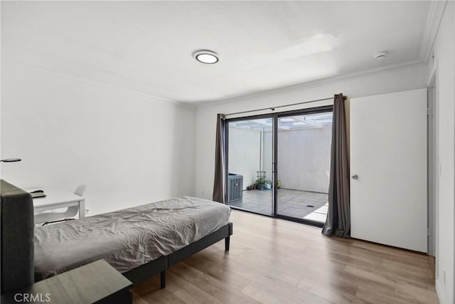 29 Morena Unit 35, Irvine, CA 92612 - bedroom featuring crown molding, wood finished floors, and access to outside