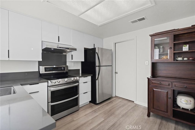 29 Morena Unit 35, Irvine, CA 92612 - kitchen with appliances with stainless steel finishes, under cabinet range hood, light wood-style floors, white cabinets, and open shelves