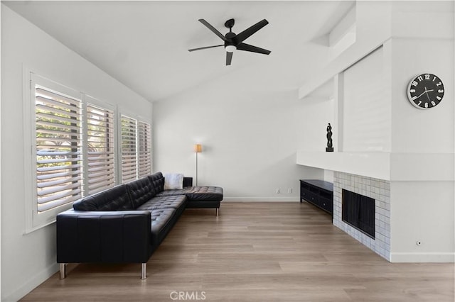 29 Morena Unit 35, Irvine, CA 92612 - living room with a ceiling fan, a tile fireplace, wood finished floors, and high vaulted ceiling