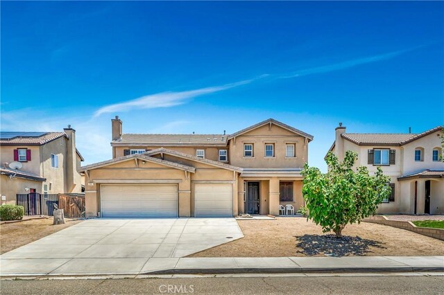 2354 Crimson Ave, Rosamond, CA 93560 - view of front of home featuring a garage, driveway, stucco siding, and covered porch