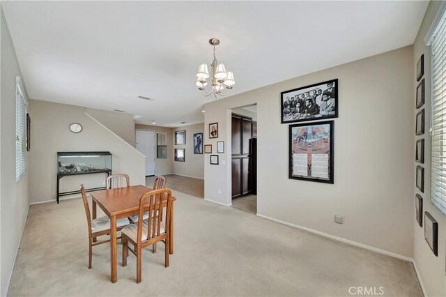2354 Crimson Ave, Rosamond, CA 93560 - dining area with light carpet and a chandelier
