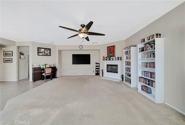 2354 Crimson Ave, Rosamond, CA 93560 - living room with a ceiling fan, a glass covered fireplace, and carpet flooring