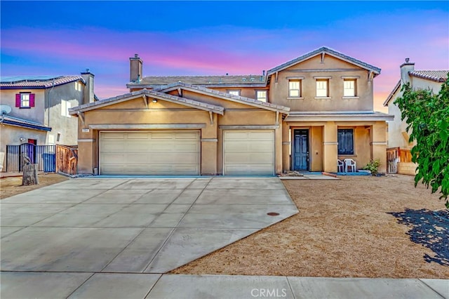2354 Crimson Ave, Rosamond, CA 93560 - view of front of house featuring concrete driveway, a garage, stucco siding, a porch, and a gate