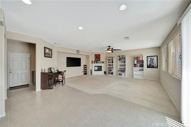 2354 Crimson Ave, Rosamond, CA 93560 - living room with light carpet, light tile patterned floors, ceiling fan, recessed lighting, and built in shelves