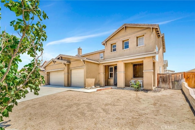 2354 Crimson Ave, Rosamond, CA 93560 - view of front facade featuring stucco siding, a garage, concrete driveway, and a chimney