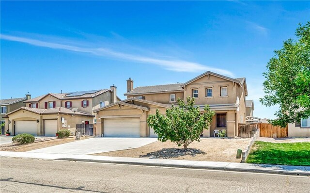 2354 Crimson Ave, Rosamond, CA 93560 - view of front facade featuring stucco siding, a garage, and driveway