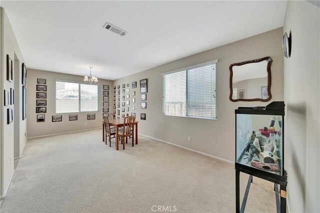 2354 Crimson Ave, Rosamond, CA 93560 - dining area featuring a chandelier and light colored carpet
