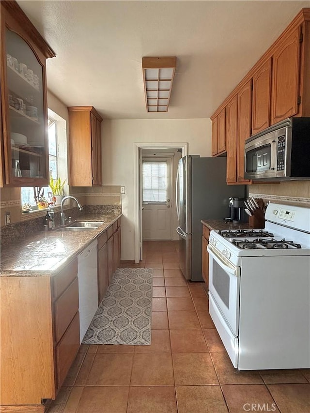 1836 Jaybrook Dr, Rancho Palos Verdes, CA 90275 - kitchen featuring white appliances, light tile patterned floors, glass insert cabinets, and brown cabinets
