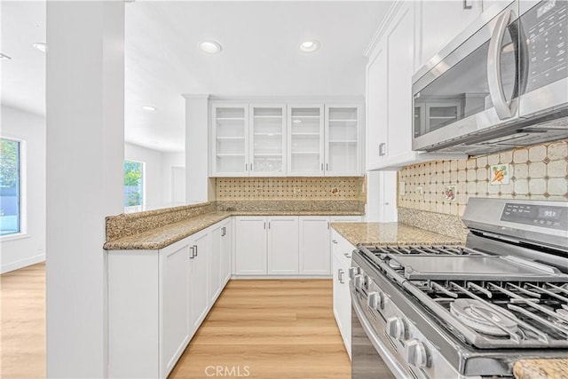 20328 Roscoe Blvd, Winnetka, CA 91306 - kitchen with stainless steel appliances, light wood-type flooring, glass insert cabinets, white cabinets, and recessed lighting