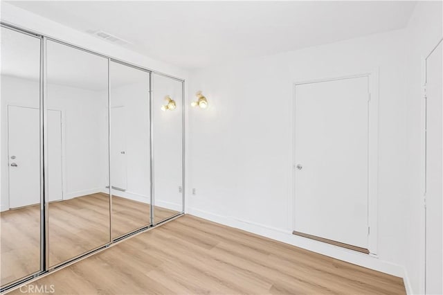 20328 Roscoe Blvd, Winnetka, CA 91306 - unfurnished bedroom with light wood-style floors and a closet
