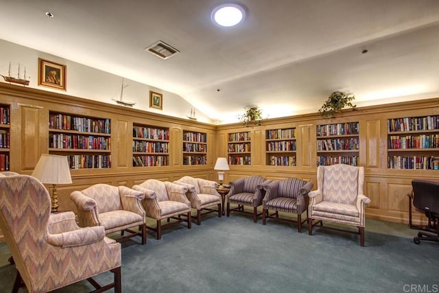 1682 Circa Del Lago Unit A306, San Marcos, CA 92078 - living area with bookshelves, vaulted ceiling, carpet, and built in shelves