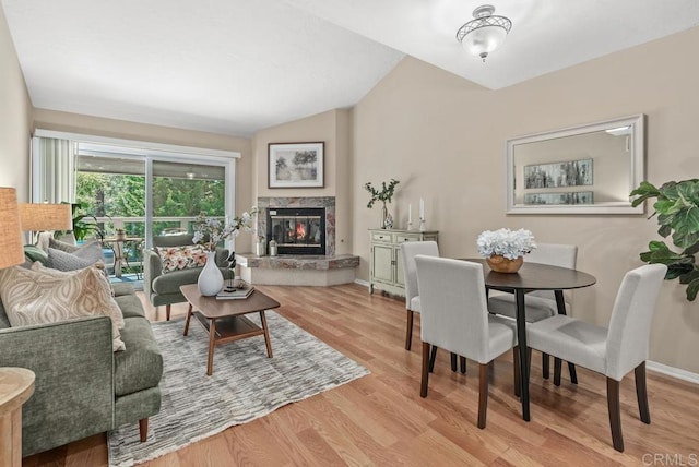 1682 Circa Del Lago Unit A306, San Marcos, CA 92078 - living room with vaulted ceiling, wood finished floors, and a premium fireplace