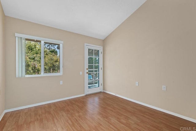 1682 Circa Del Lago Unit A306, San Marcos, CA 92078 - spare room featuring wood finished floors and vaulted ceiling